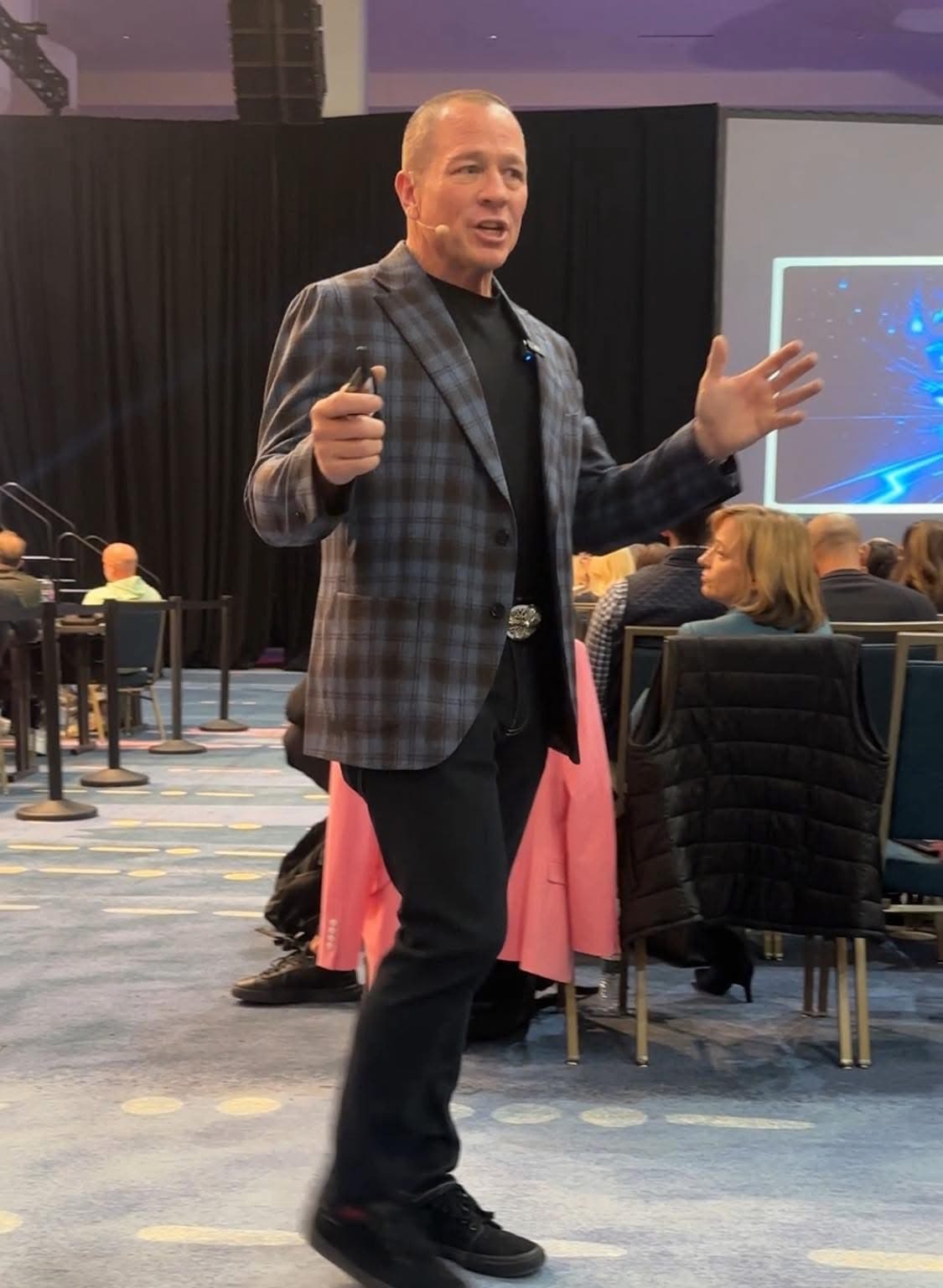 Aaron Cuha presenting at a live event