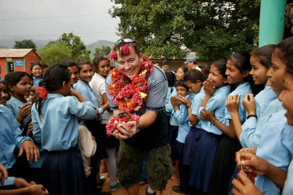 Aaron Cuha welcomed by schoolchildren in Nepal with flower garlands